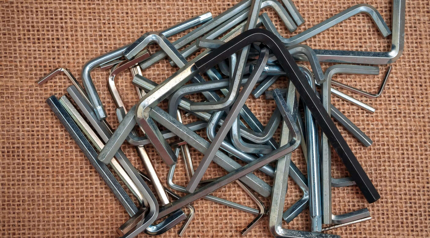 Various allen key sets including imperial and torx keys, arranged on a textured surface.