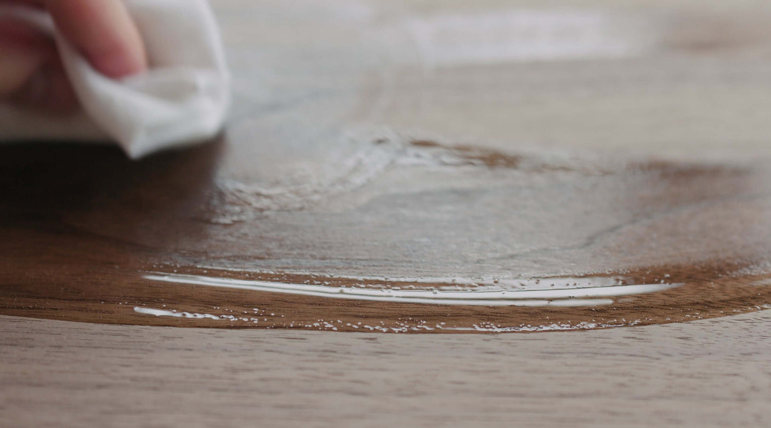 Applying mineral oil to a wooden chopping board for maintenance and preservation.