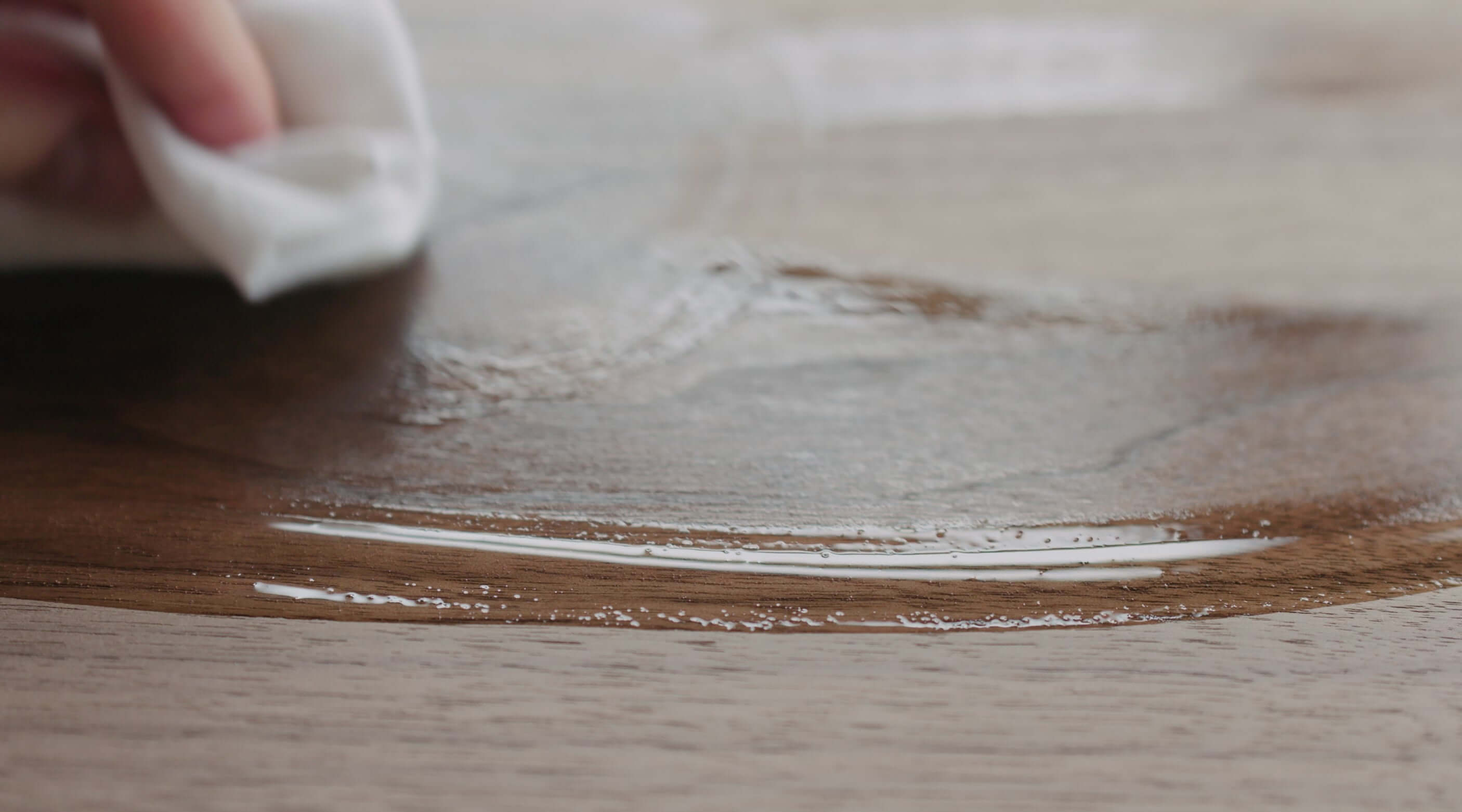 Applying mineral oil to a wooden chopping board for maintenance and preservation.